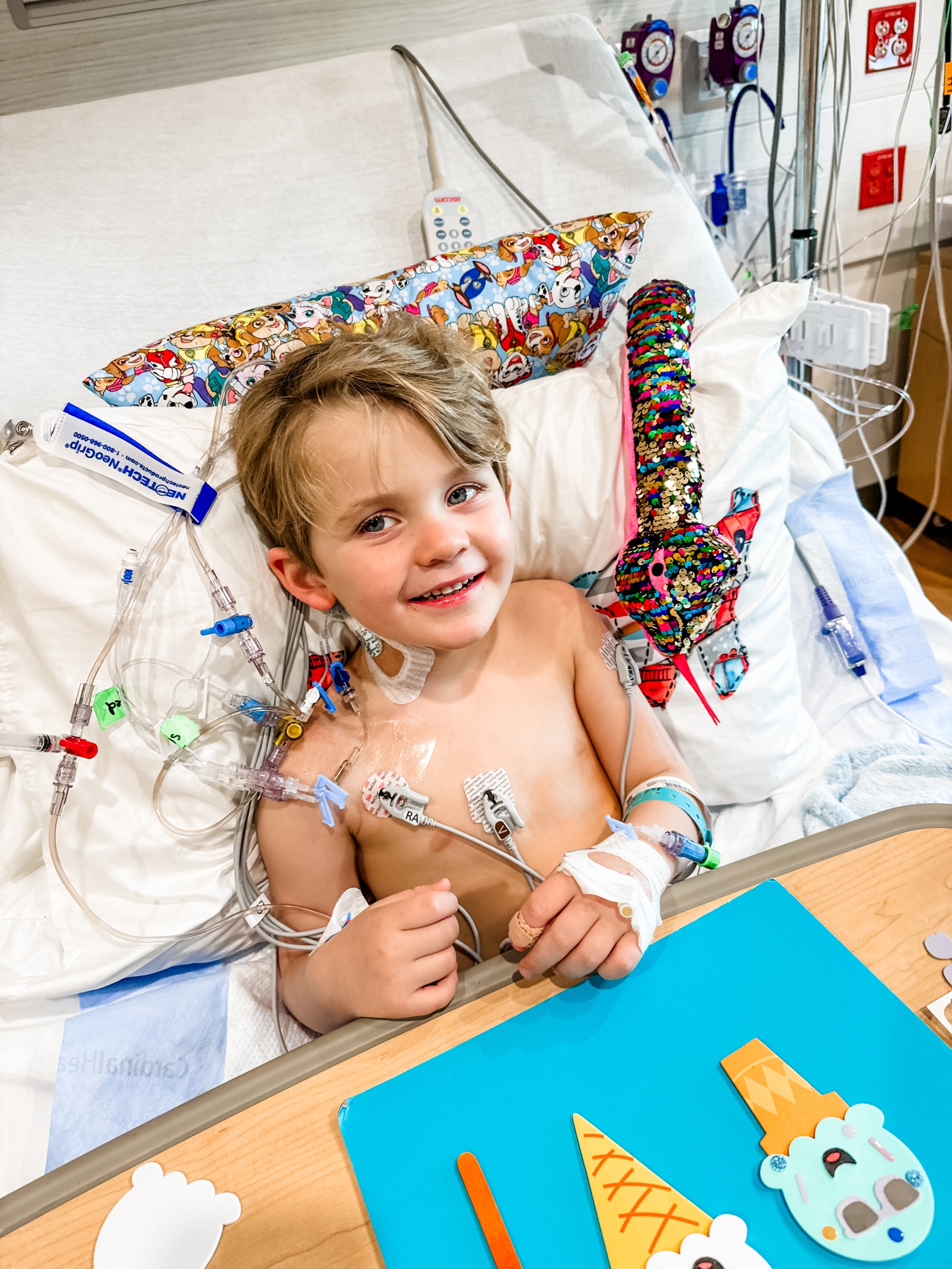 Know in a hospital bed smiles while making ice cream crafts.